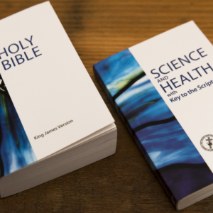 Bible and Science and Health with Key to the Scriptures on a study desk
